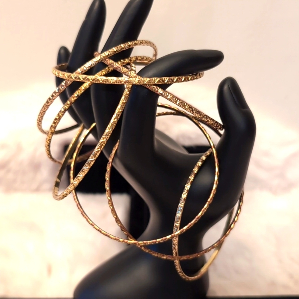 Eight Gold Toned Bangles "Jingles" Textured Pattern